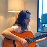 A designer plays the guitar
